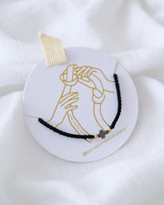 PULSERA CRUZ HEMATITA CON HILO DOBLE