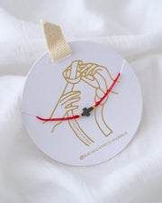PULSERA CRUZ HEMATITA CON HILO SENCILLO