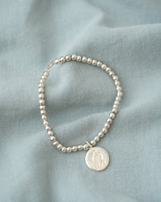 PULSERA ESFERAS CON MEDALLA DESATADORA PLATA .925