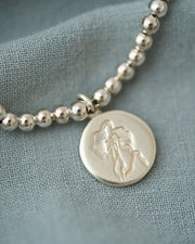 PULSERA ESFERAS CON MEDALLA DESATADORA PLATA .925