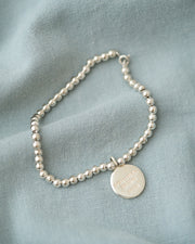 PULSERA ESFERAS CON MEDALLA DESATADORA PLATA .925